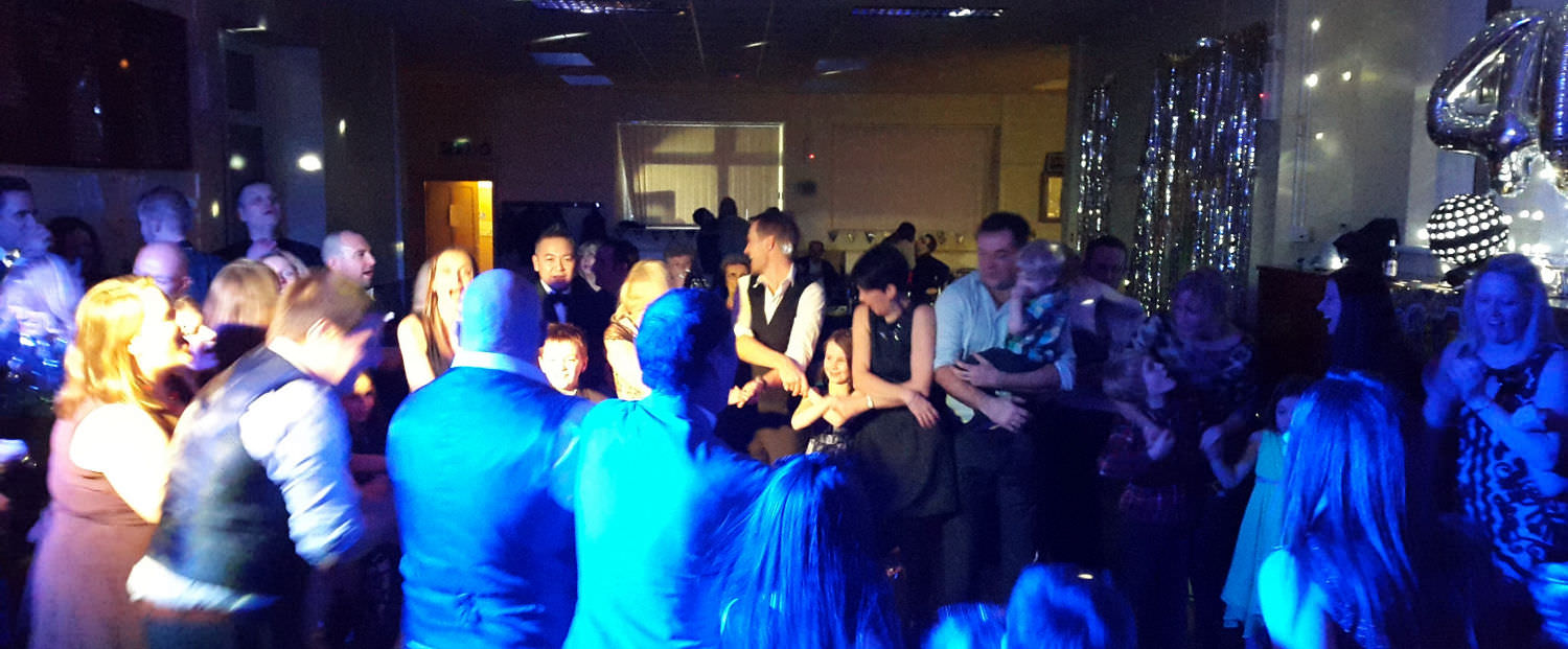 People at a wedding reception, dancing to the sounds of Jon Paul Entertainment.