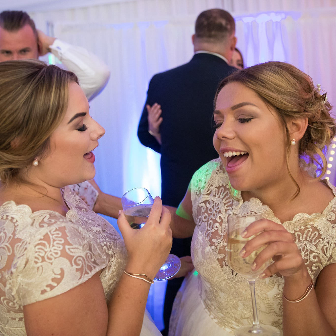 Two women wedding guests dancing and enjoying themselves.